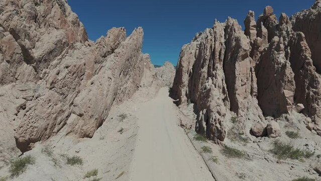 Drone advancing over a stone cliff in the Quebrada de las Flechas, on a beautiful sunny day in the province of Salta, Argentina.