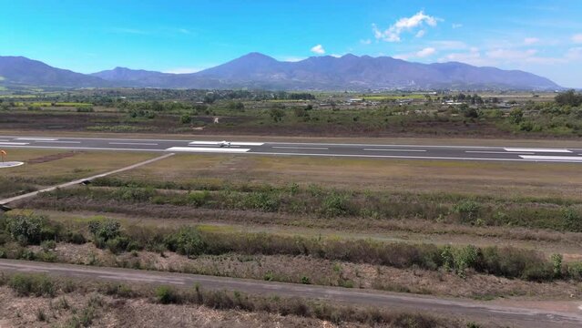 Aerial shot of an plane takeoff in Mexico Nayarit, airfields, and mountains backgrounds