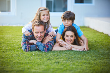 Portrait of mother, father and children in backyard for bonding, love and relationship on grass. Happy, family and dad, mom and kids on lawn for playing, childhood and relax together on weekend