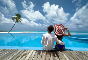Fototapeta na wymiar Happy moment with Couple in white dress near swimming pool at Maldives