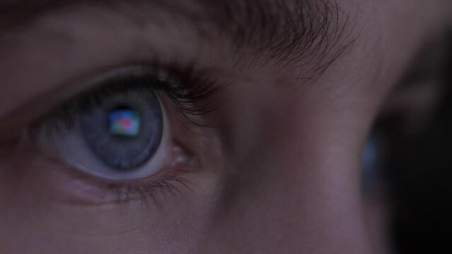 Child in Dark is Watching TV Playing Video Game. Close-up Face of Little Girl Kid Eyes. Girl Watch Television on Living Room. Video Game Entertainment Addiction Child Using Tablet, Smartphone Computer