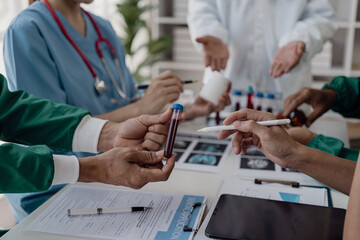 Medical team meeting discusses case of patient being treated for brain cancer at hospital lab....