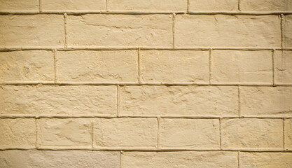 Obraz premium Brick wall texture background, sandy yellow color