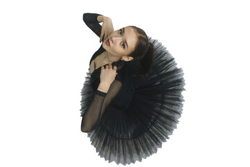 portrait of a young ballerina in a black tutu dancing with her hands moving top view, immersion in...