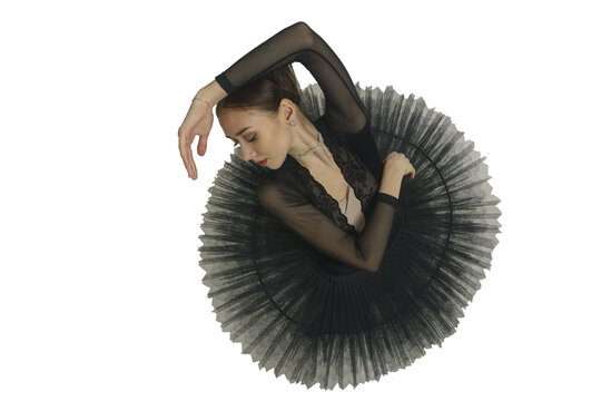 portrait of a young ballerina in a black tutu dancing with her hands moving top view, immersion in dance, isolated on transparent background, png