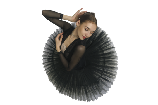 portrait of a young ballerina in a black tutu dancing with her hands moving top view, immersion in dance, isolated on transparent background, png