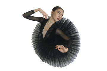 portrait of a young ballerina in a black tutu dancing with her hands moving top view, immersion in...