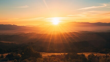 Golden sunset over rolling hills and mountains with sun rays and clear sky landscape nature scenery...