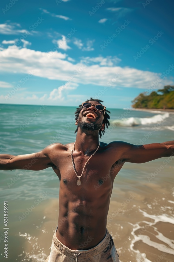 Poster a man is smiling and laughing while standing in the ocean. he is wearing sunglasses and a necklace