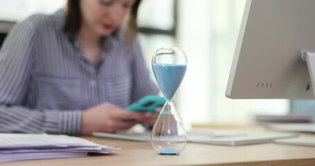 Woman manager is distracted from work and uses smartphone and social networks