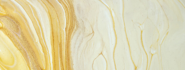 Abstract fluid art background yellow and golden colors. Liquid marble. Acrylic painting with beige...