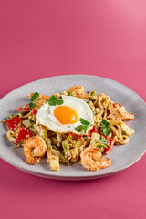 Seafood and Egg Udon in Eastern Lagman Style on Pink Background - Delicious Asian Fusion Cuisine