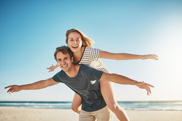 Portrait, piggy back and seaside with couple, love and sunshine with happiness, summer and romance....
