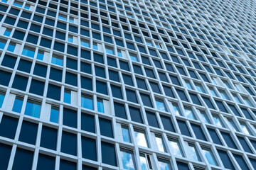 large building with many windows and a blue sky in the background