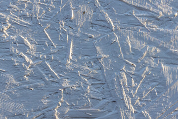 The texture of a chipboard in white paint