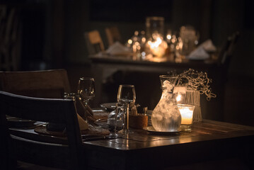 Close up of a dinner table, rustic, candle light, moody, 