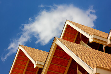 rubber roof tiles on steel structure  triangle shape pattern agianst blue sky construction site