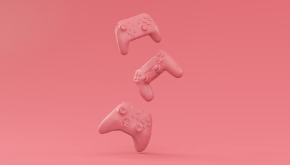 Video game joysticks or gamepads in plain monochrome pink color background