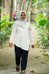 Fototapeta premium Asian female model in white hijab is in the park