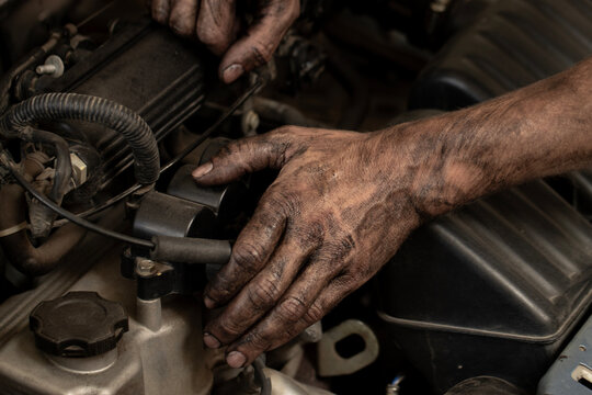 Dirty male hands close-up. An auto mechanic repairs and diagnoses cars, close-up.
