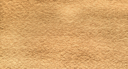 Yellow brown felt texture abstract background. Surface of fabric texture in brown color. 