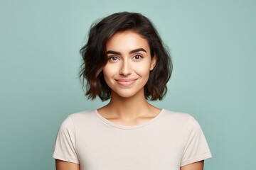 Fototapeta premium A woman with short hair and a white shirt is smiling