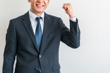 やる気に満ちたビジネスマン（ガッツポーズ・成功・笑顔・やる気）
