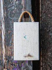 Old white wooden blank signboard on the old aged wall background