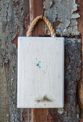 Old white wooden blank signboard on the old aged wall background