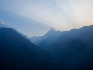 Fototapeta premium Sun is illuminating mountains above valley