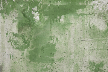 concrete wall and traces of green paint close-up