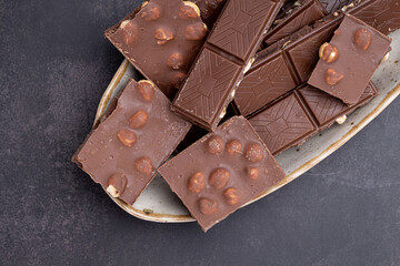 Chocolate cupcake with icing and chocolate bar in Dark lighting,Homemade delicious chocolate muffin on wooden background close-up