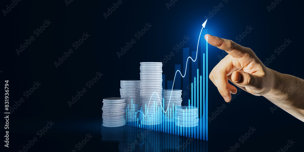 Poster close up of male hand pointing at creative hologram with growing chart and stacked coins on dark bac