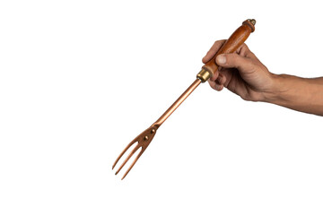 Black male hand holding a vintage brass meat fork on white background