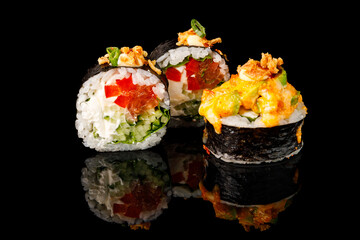 Sushi Hot Roll, Sushi menu. Japanese food.Set with fried and baked rolls, sushi on a black board on a light table.