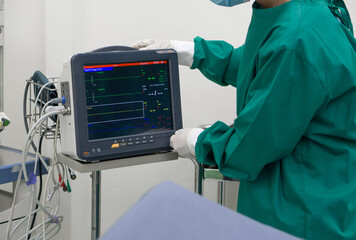 A dedicated healthcare professional in a sterile surgical gown maneuvers a high-tech machine, the...