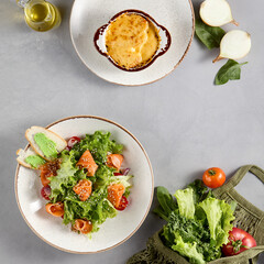 Fresh salmon salad and onion soup topped with melted cheese, great for a healthy meal option and culinary websites