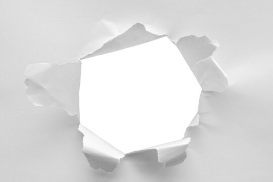 Torn ripped paper hole isolated on white background