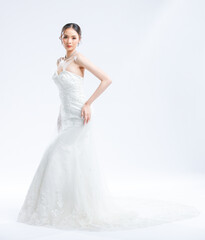 Fototapeta premium Asian young beautiful female portrait attractive model gorgeous charming bride wearing fashion wedding dress luxury perfect style, posing standing smile looking camera isolated white background studio