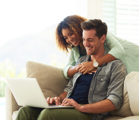 Happy, laptop and couple hug on sofa for bonding, man and woman relax together in home. Love,...