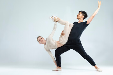 Ballet Dance Ideas and Concepts. Sportive Couple of Asian Man and Caucasian Woman Performing As...