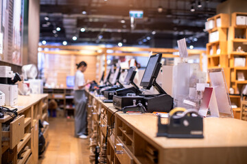 Selective focus to edge of POS machine with blurry cashier staff receive orders from customers at...