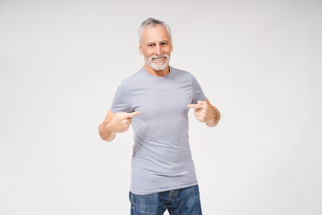 Portrait of happy gray-haired bearded man pointing himself looking at camera, isolated on white