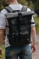 Black leather backpack on a man at the city