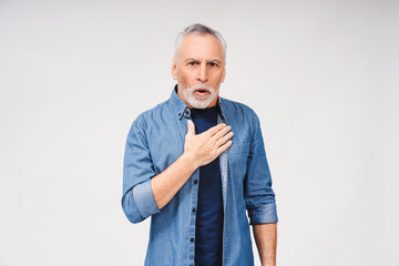 Portrait of surprised senior gray-haired man looking at camera posing on white background