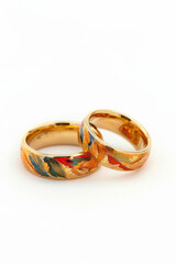 A pair of gold wedding rings in isolation on a white background.