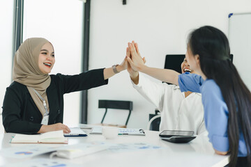 Cheerful and diverse business colleagues celebrating success.