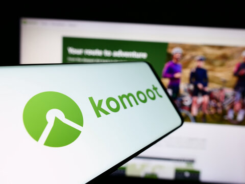 Stuttgart, Germany - 05-23-2024: Cellphone with logo of German route planning app company komoot GmbH in front of business website. Focus on center-left of phone display.