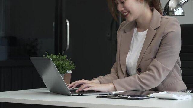young Asian businesswoman, dressed in a formal suit, navigates complexities of the stock market as a consultant, loan officer, financial advisor, embodying entrepreneurship and strategic prowess.
