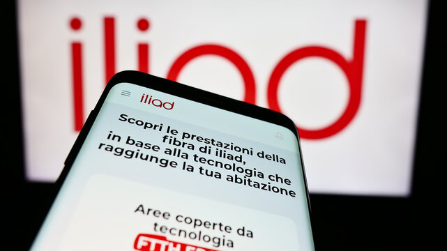 Stuttgart, Germany - 05-23-2024: Mobile phone with website of telecommunications company Iliad Italia S.p.A. in front of business logo. Focus on top-left of phone display.
